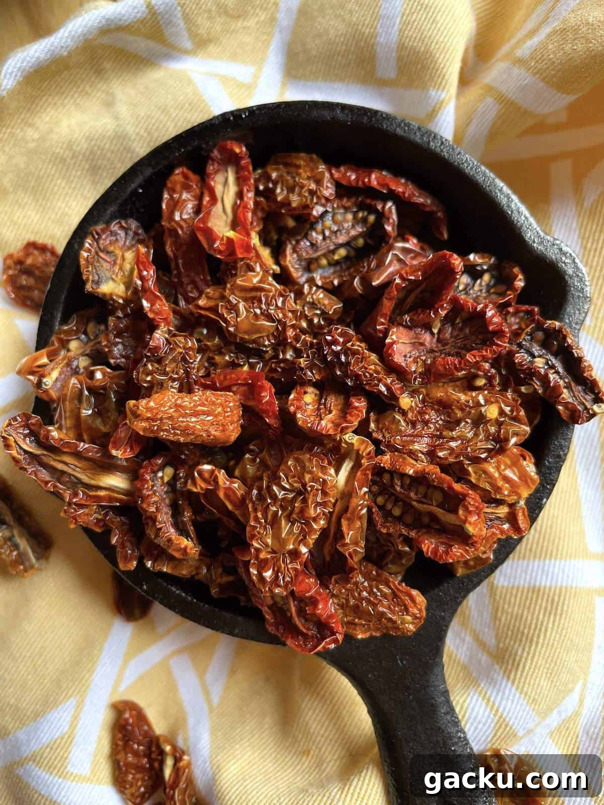 Dehydrating Cherry Tomatoes: Step-by-Step Guide for Perfect Results 8 A tiny cast iron pan filled with sun-dried cherry tomatoes.