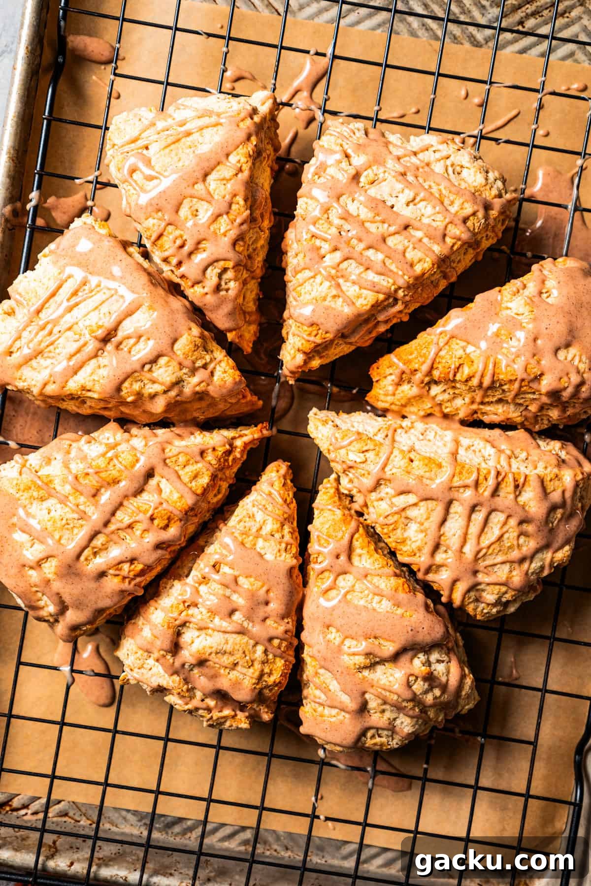 Baked and glazed cinnamon scones. Baked and glazed cinnamon scones on a wire rack.