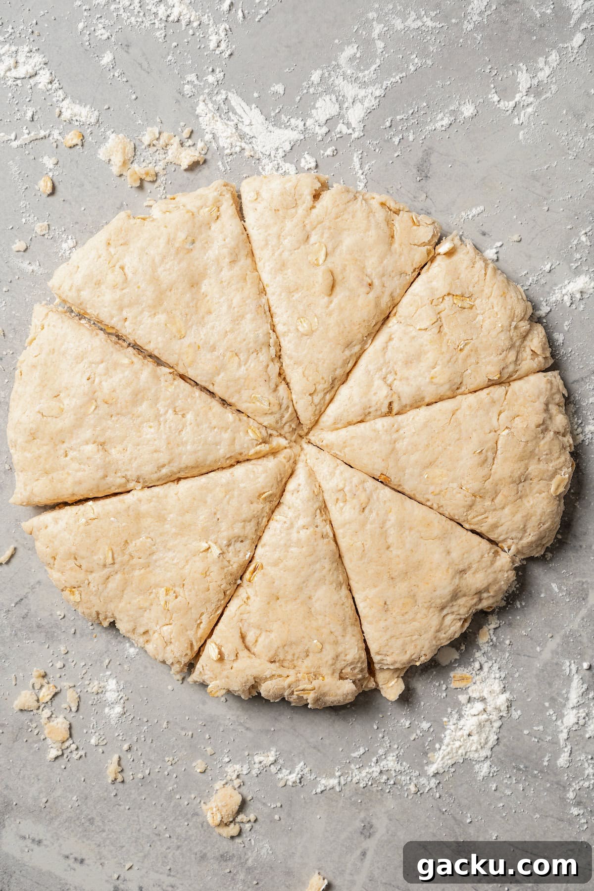 Shape and cut into wedges. Scone dough shaped into a disc and cut into wedges on a floured countertop.
