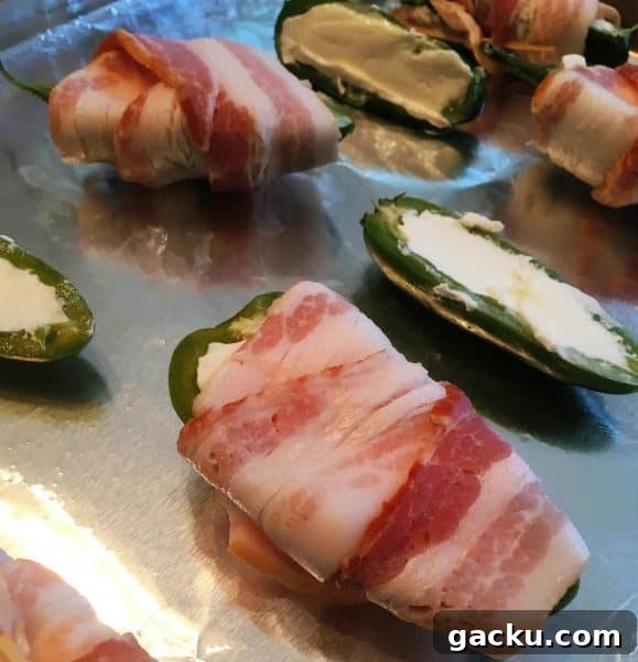 Cheesy Stuffed Jalapeños: Crispy Bacon-Wrapped Poppers Recipe 3 Fresh Jalapeno Poppers sliced in half, stuffed with cream cheese, and wrapped in bacon.