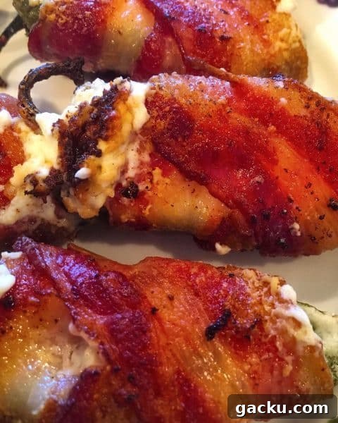 Cheesy Stuffed Jalapeños: Crispy Bacon-Wrapped Poppers Recipe 5 stuffed jalapeno peppers with cream cheese wrapped in crispy bacon