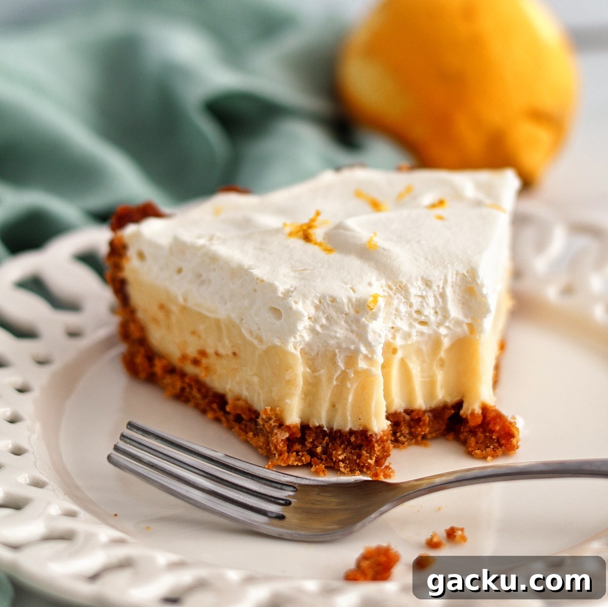 Gluten-Free Lemon Pie Recipe: Zesty Tart with Buttery Crust 15 half eaten piece of lemon pie on white scalloped plate.