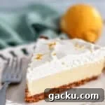 Gluten-Free Lemon Pie Recipe: Zesty Tart with Buttery Crust 16 gluten free lemon pie on white scalloped plate with lemon and light green towel in the background.
