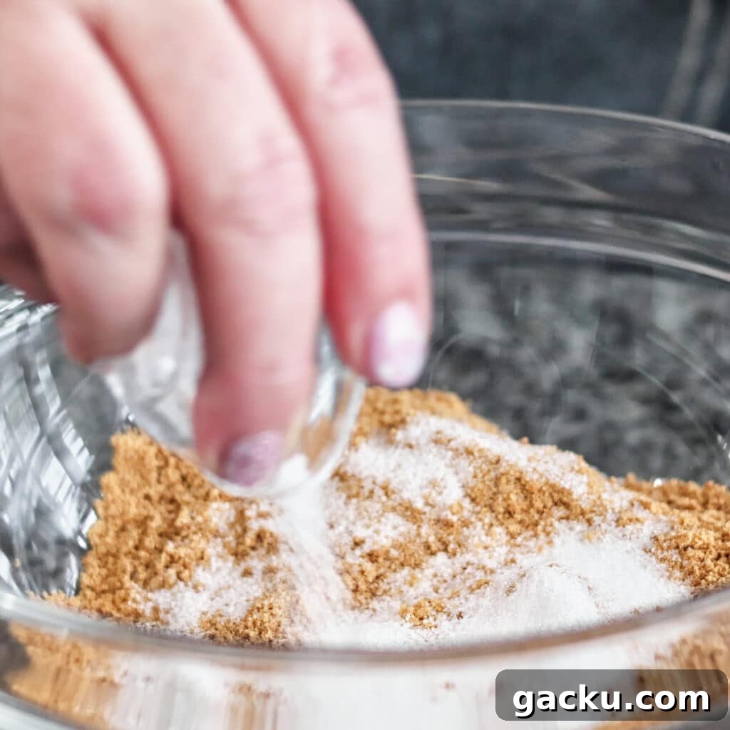 Gluten-Free Lemon Pie Recipe: Zesty Tart with Buttery Crust 4 adding sugar to graham cracker crumbs in a large glass bowl.