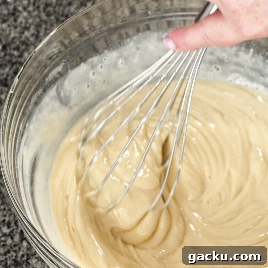 Gluten-Free Lemon Pie Recipe: Zesty Tart with Buttery Crust 8 whisking filling ingredients together in a large glass bowl.