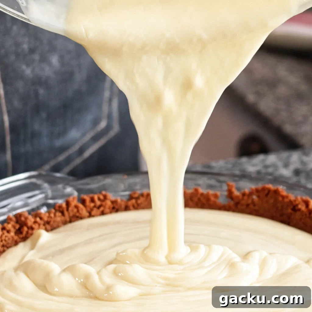 Gluten-Free Lemon Pie Recipe: Zesty Tart with Buttery Crust 9 pouring filling into baked crust.