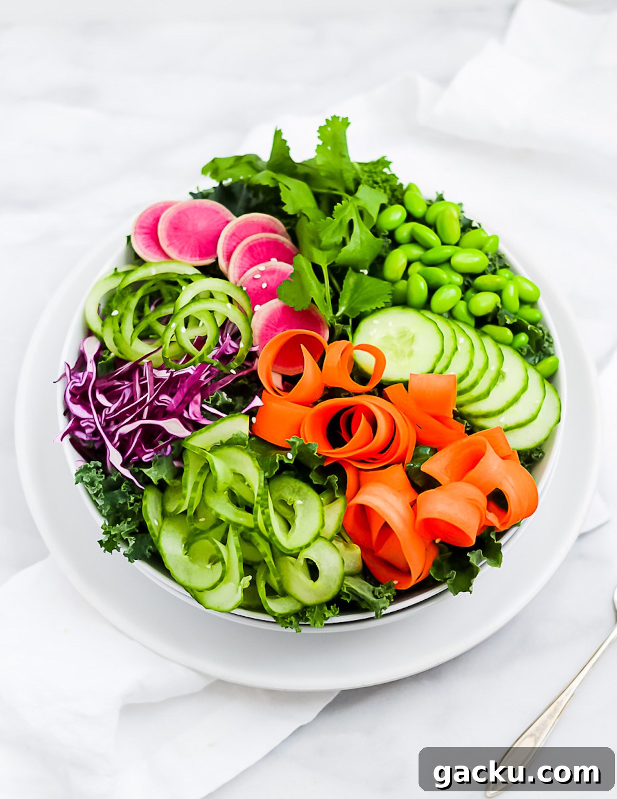 Sesame Ginger Salad Dressing Recipe for Crisp Greens 2 A large kale salad topped with carrots, cucumbers, radishes, cabbage, and edamame.