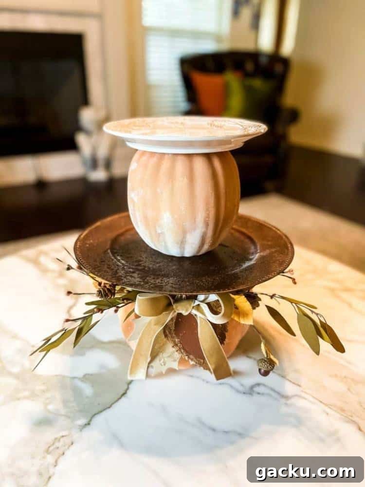 15 Fall DIY Home Decor Crafts to Transform Your Space 8 pumpkins and plates stacked to create a tiered tray look