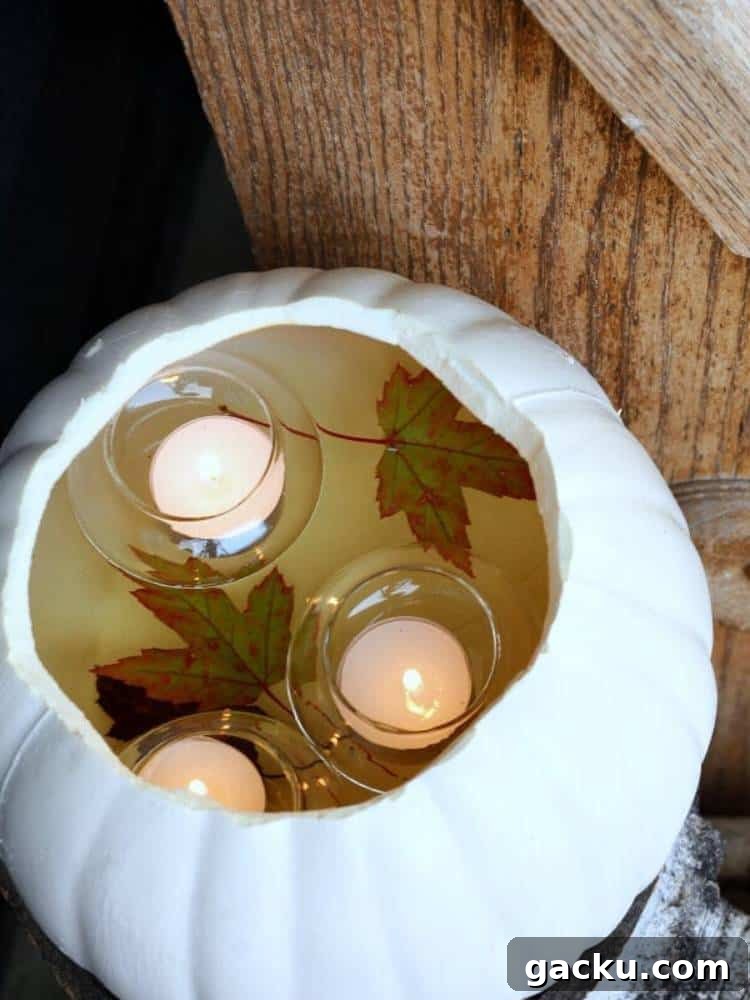 15 Fall DIY Home Decor Crafts to Transform Your Space 9 floating candles and fall leaves in open top white pumpkin