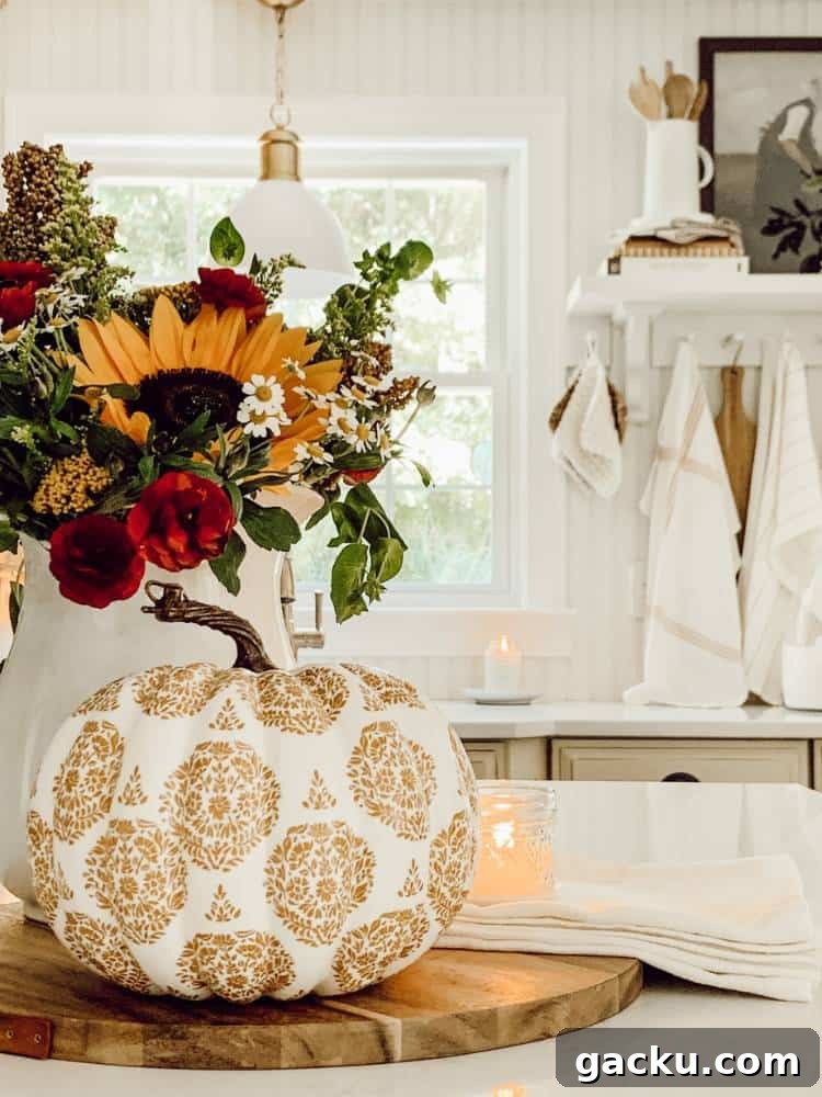 15 Fall DIY Home Decor Crafts to Transform Your Space 10 fall gold decoupage pumpkin next to fresh cut flowers in vase