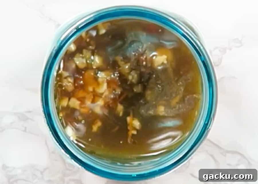 30-Minute Baked Orange Chicken (Low-Calorie, Crispy) 5 Orange Sauce ingredients in a jar for the Baked Skinny Orange Chicken (Easy 30-minute meal)