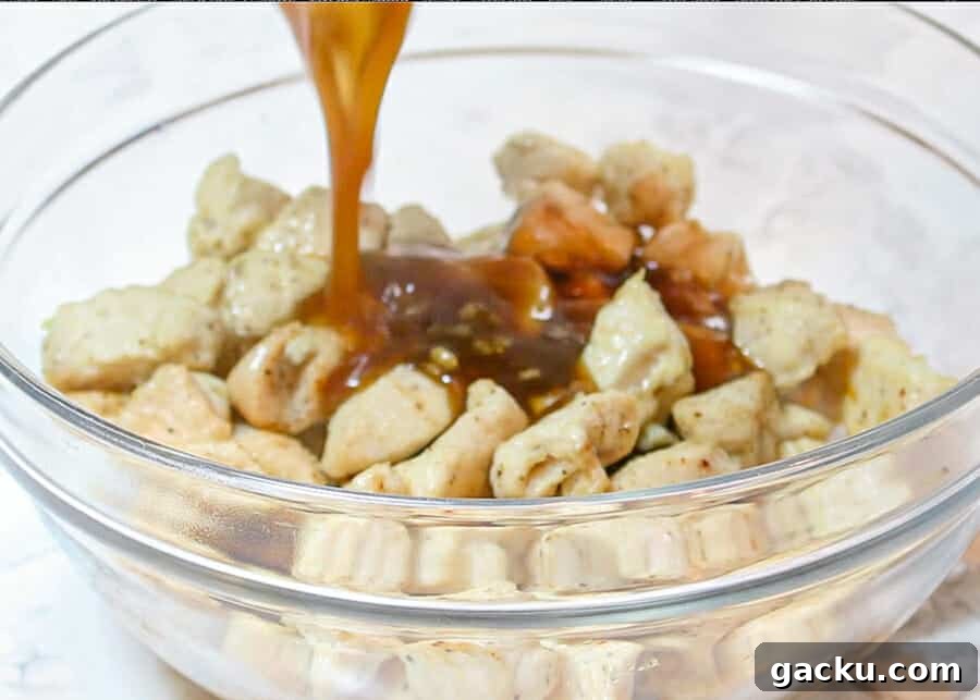 30-Minute Baked Orange Chicken (Low-Calorie, Crispy) 9 poring the orange sauce onto the chicken