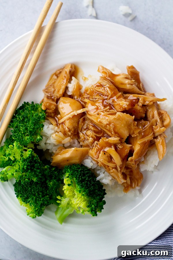Plate of slow cooker Mongolian chicken over rice with broccoli