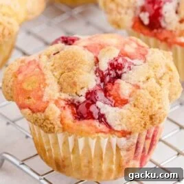 White Chocolate Raspberry Muffins with Fresh Raspberries 9 close up shot of cherry cobbler muffins in a cooling rack