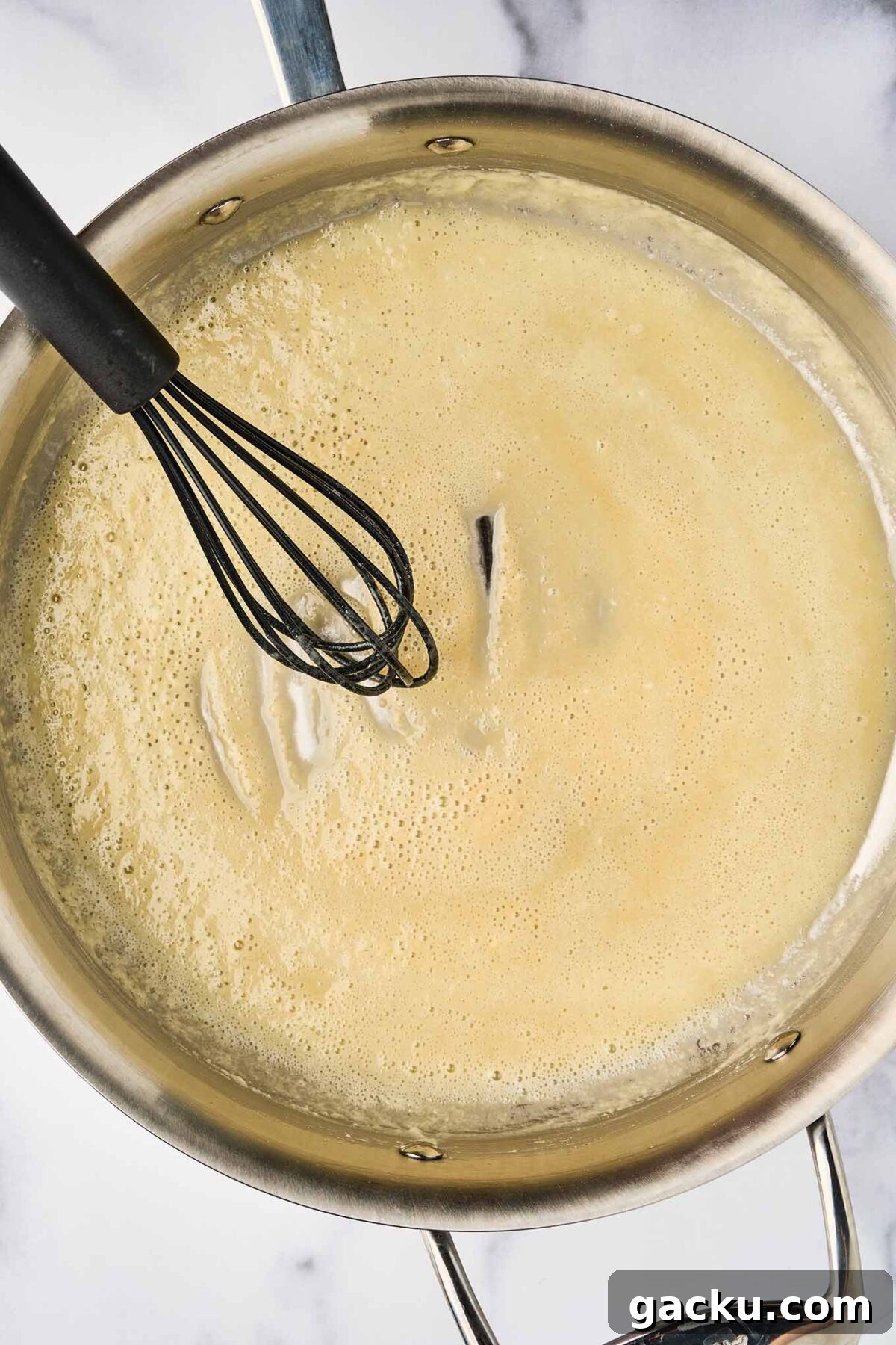 Herbed French Macaroni & Cheese with Ham 3 Butter and flour roux being whisked for béchamel sauce in French macaroni and cheese.