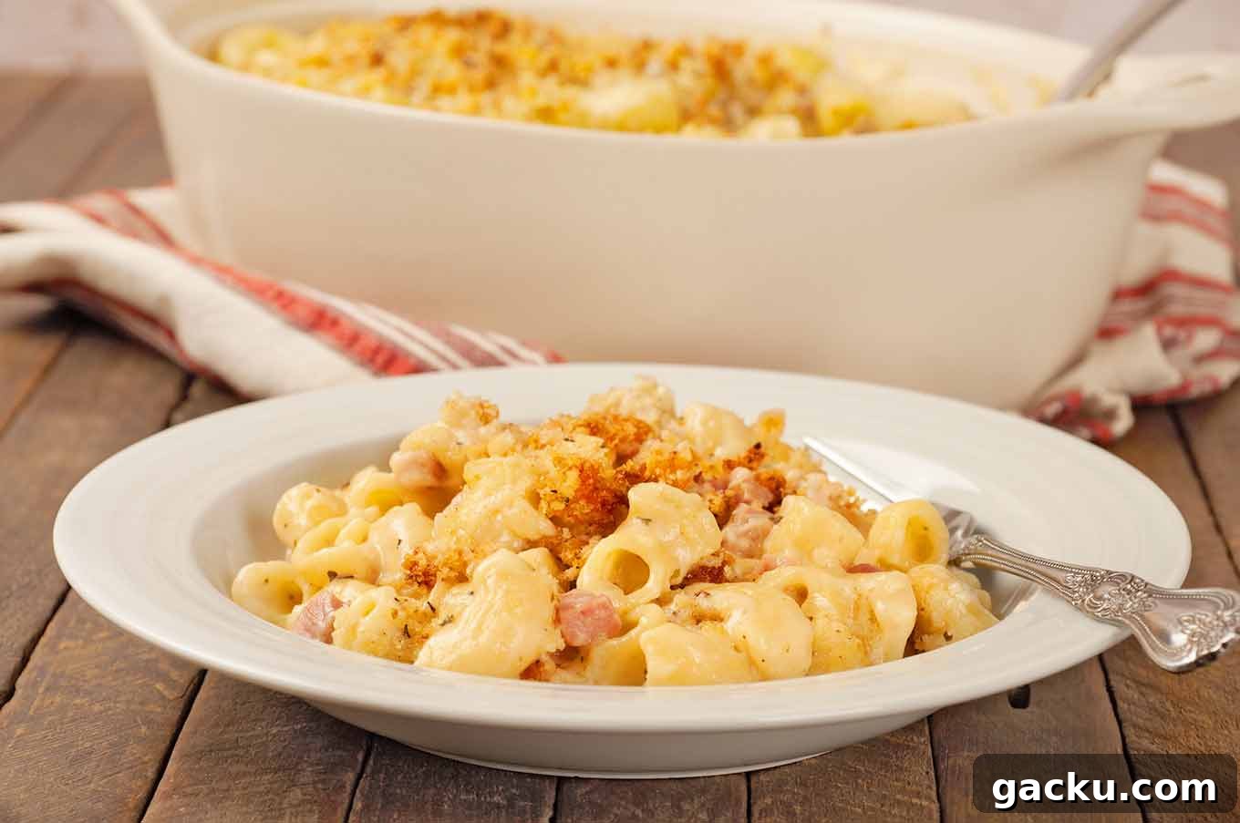 Herbed French Macaroni & Cheese with Ham 6 Serving of French macaroni and cheese with ham and toasted panko topping plated in shallow bowl.