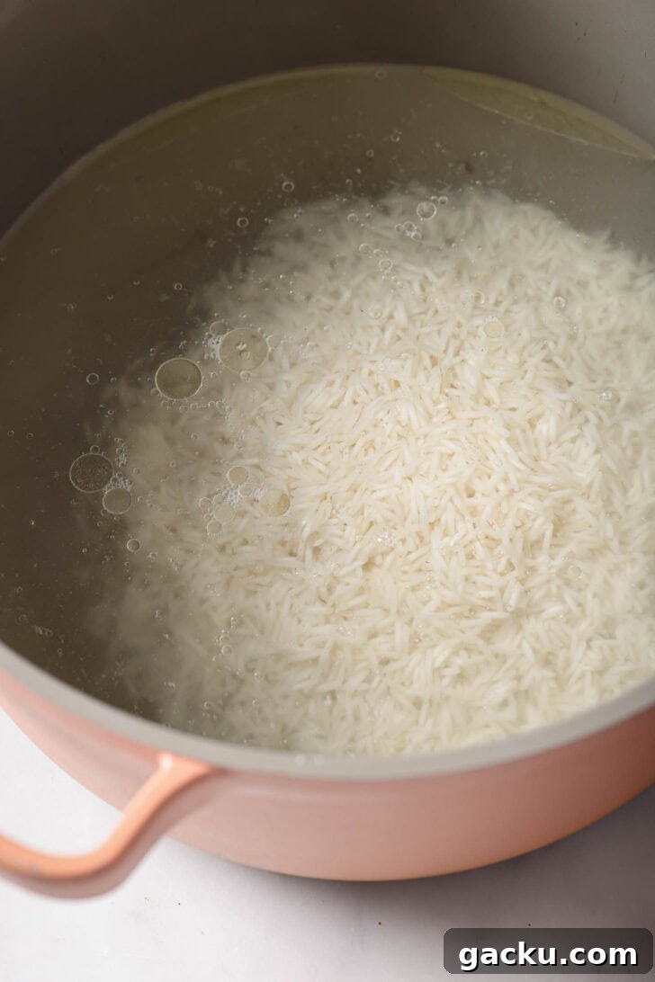 Indo-Chinese Basmati Fried Rice Recipe 8 Rice added to pot of boiling water to cook.