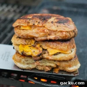 Croissant Smash Burger Recipe: Crispy-Buttery Smash Burger Guide 10 A stack of croissant three smashburgers on a cast iron skillet over the grill