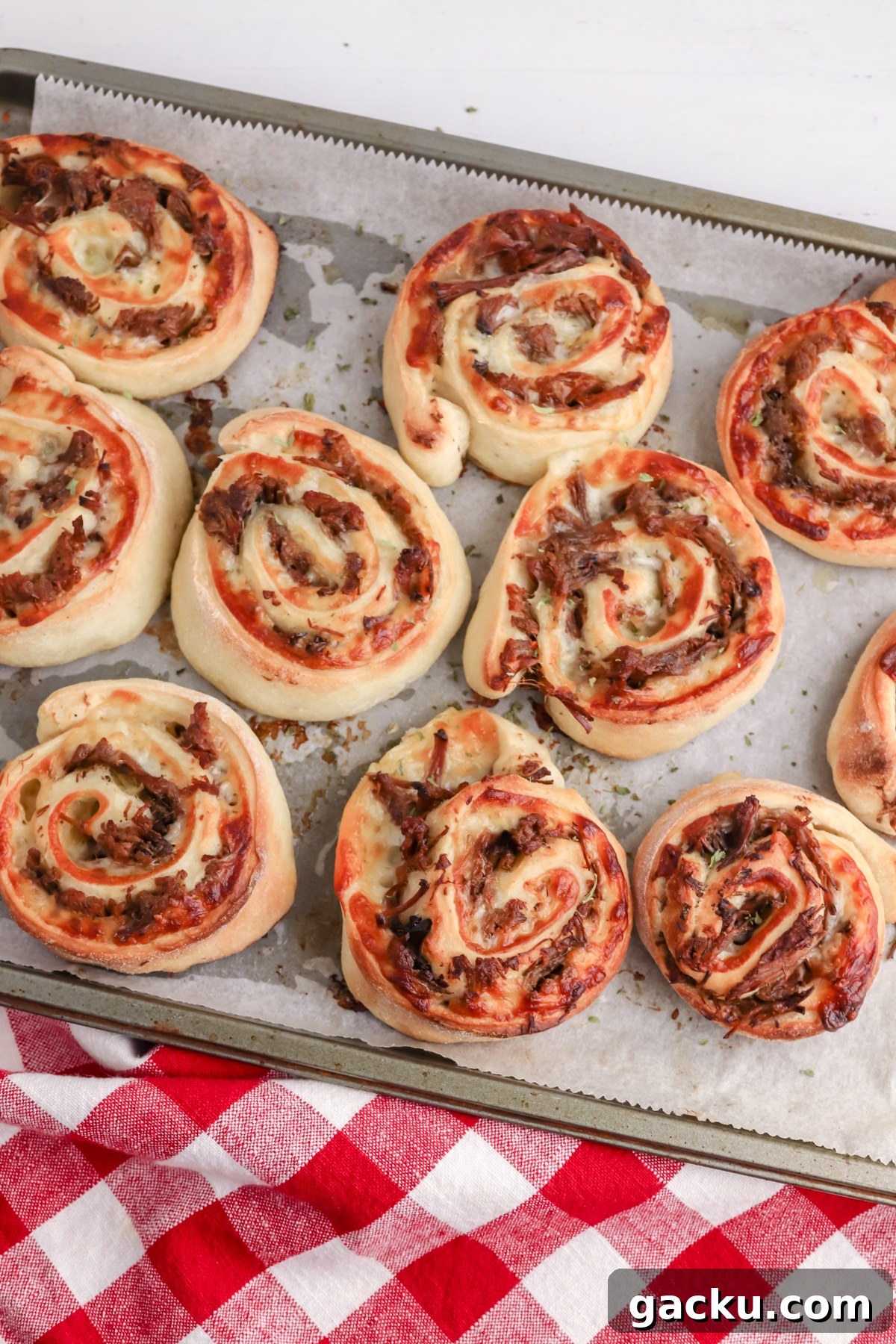 italian beef pinwheels on baking sheet