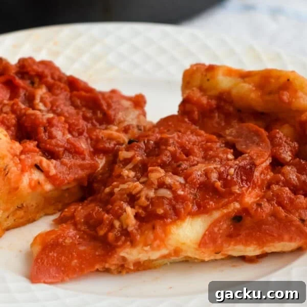 Slices of sourdough deep dish pizza on a plate.