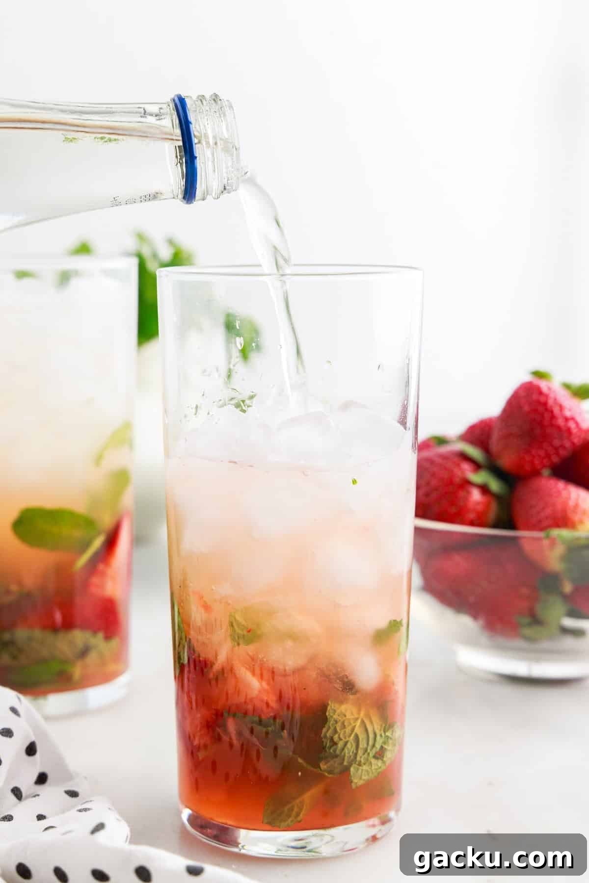 Sparkling water being added to the Strawberry Mojito.