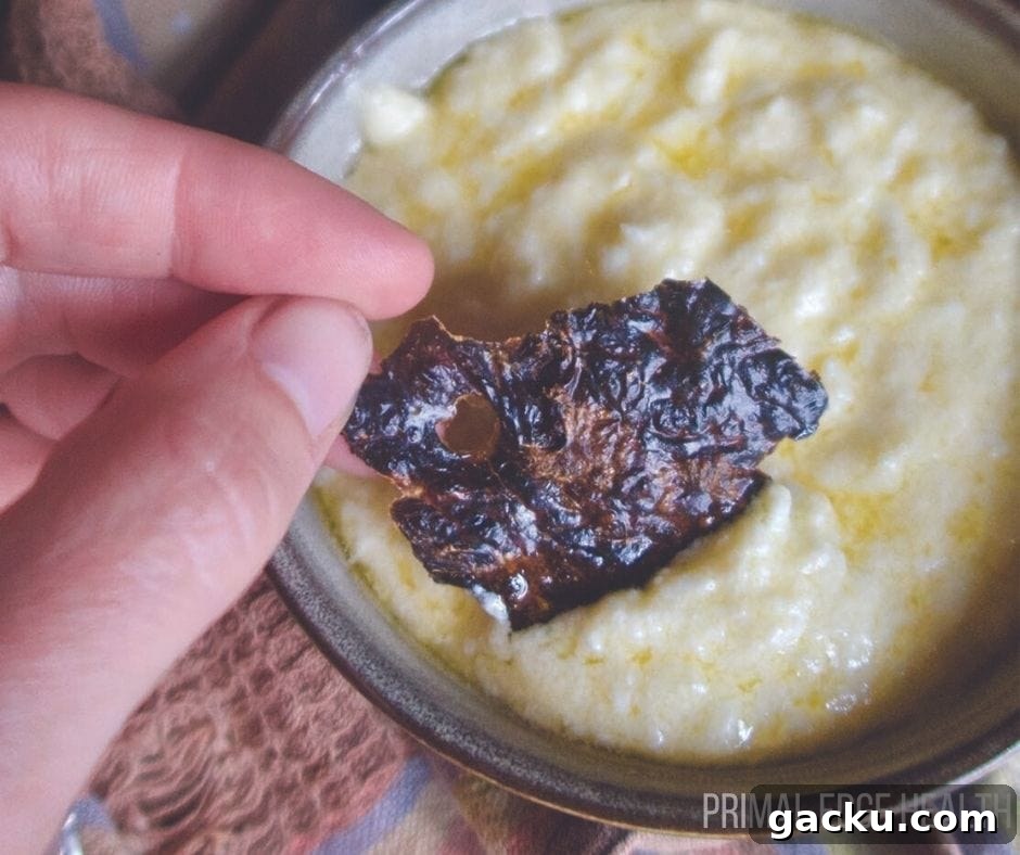 A liver chip being dipped into a yellow sauce.