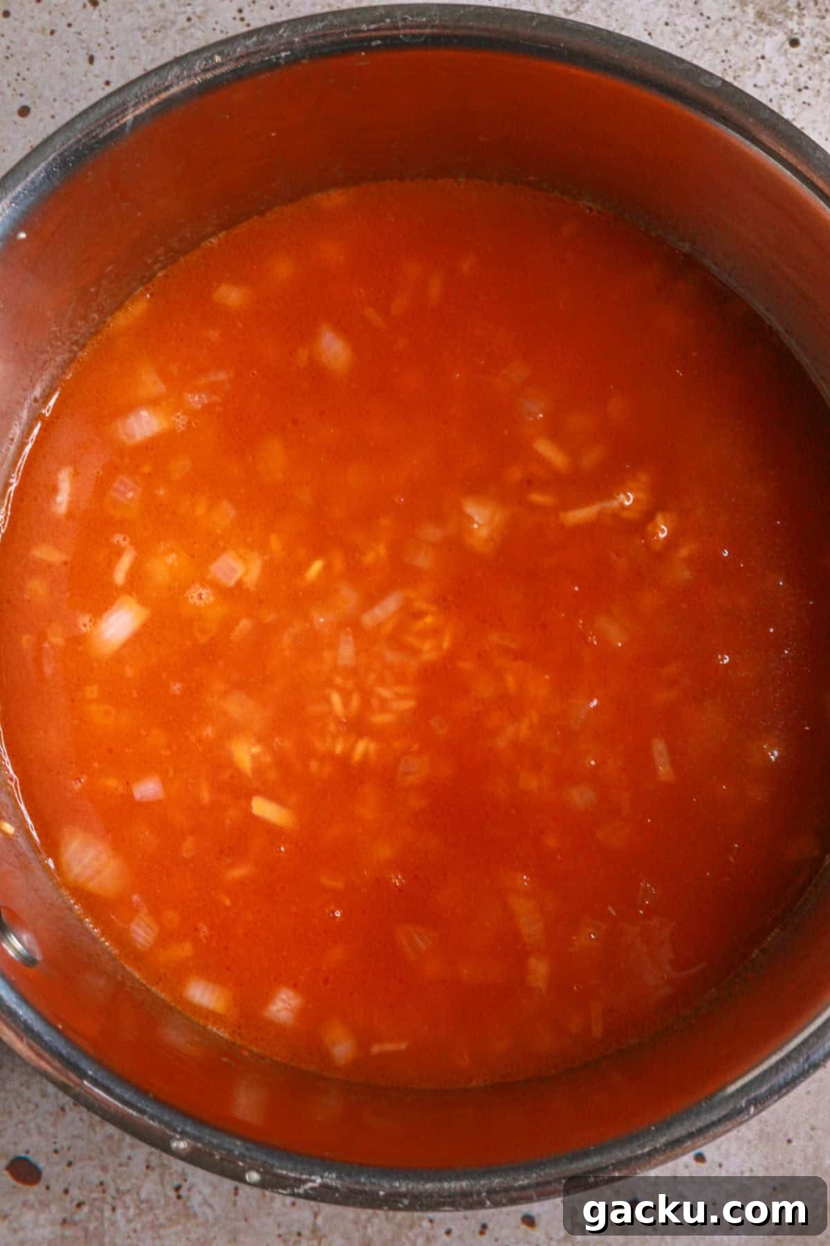 Authentic Mexican Red Rice Recipe: Fluffy, Flavorful Arroz Rojo 7 Add broth, tomato sauce and salt