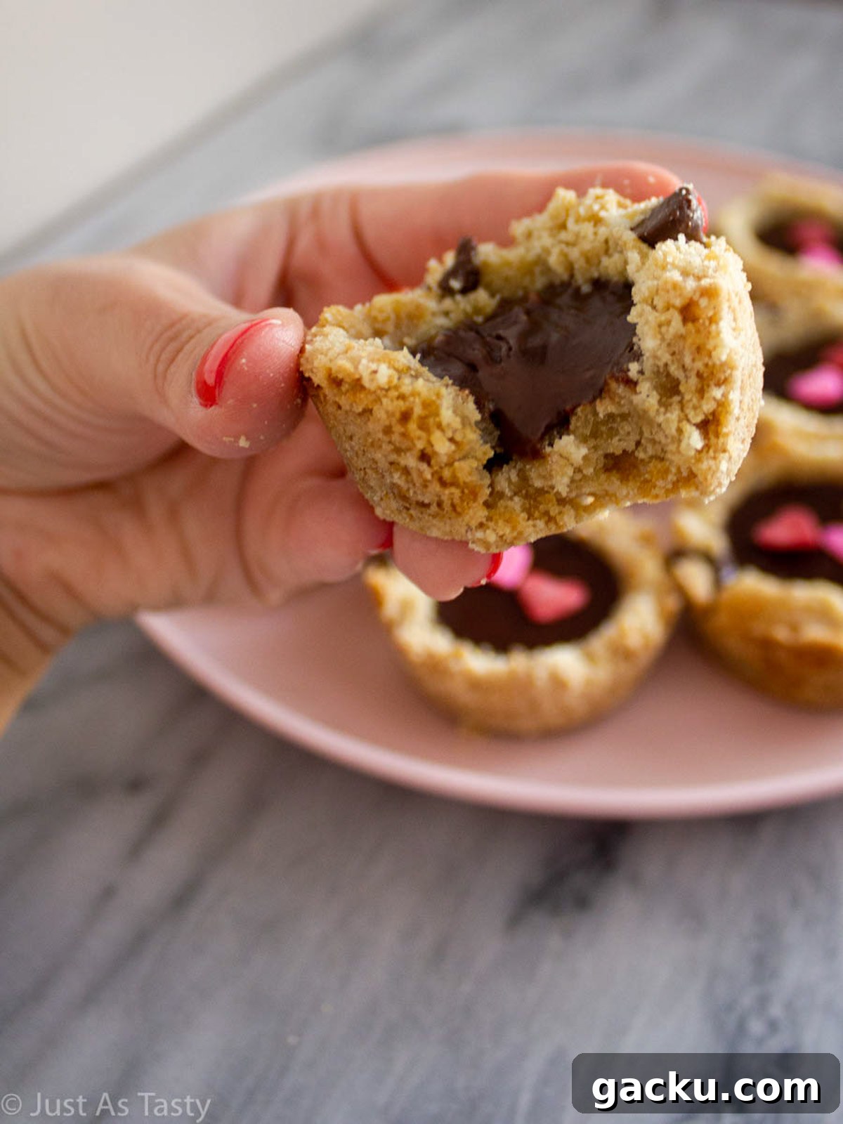 Chocolate Chip Cookie Cups Recipe — Mini Baked Cookie Desserts 4 Close-up of a cookie cup filled with chocolate ganache.