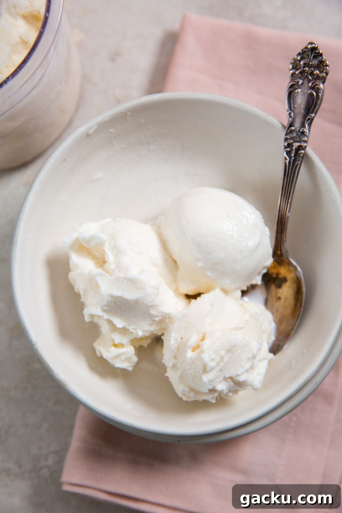 Ninja Creami Vanilla Ice Cream in a white bowl with a spoon and pink napkin