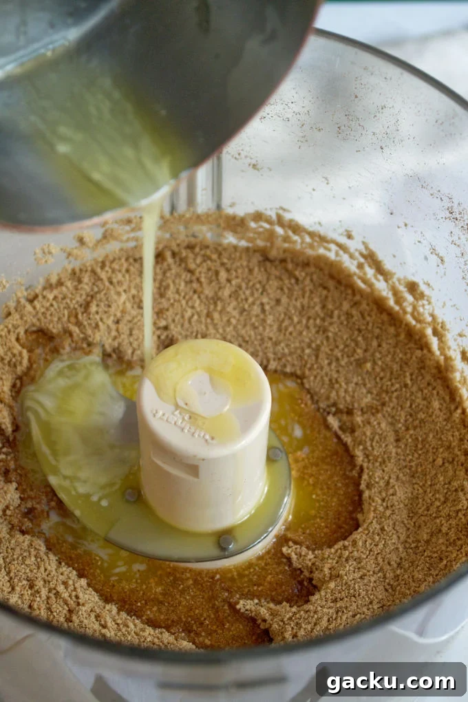 Mini Peanut Butter Espresso No-Bake Cheesecakes 7 butter being poured into graham cracker crumbs