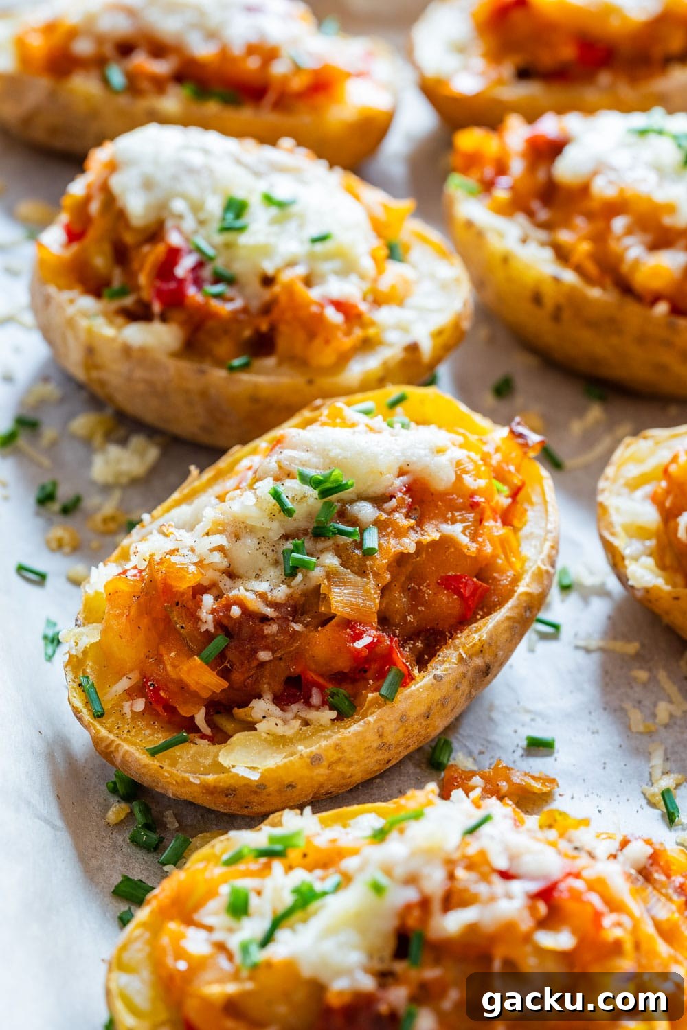 Ultimate Twice-Baked Potatoes Recipe for Crispy, Cheesy Potatoes 2 Twice baked potatoes topped with cheese.