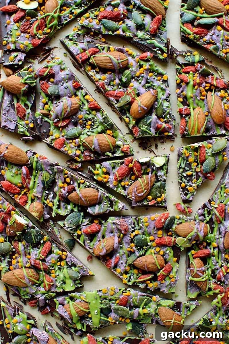 Superfood Chocolate Bark Recipe with Nuts & Seeds 5 Superfood chocolate bark - dark chocolate topped with almonds, goji berries, seeds, bee pollen and white chocolate flavoured with matcha and freeze dried blueberry powder