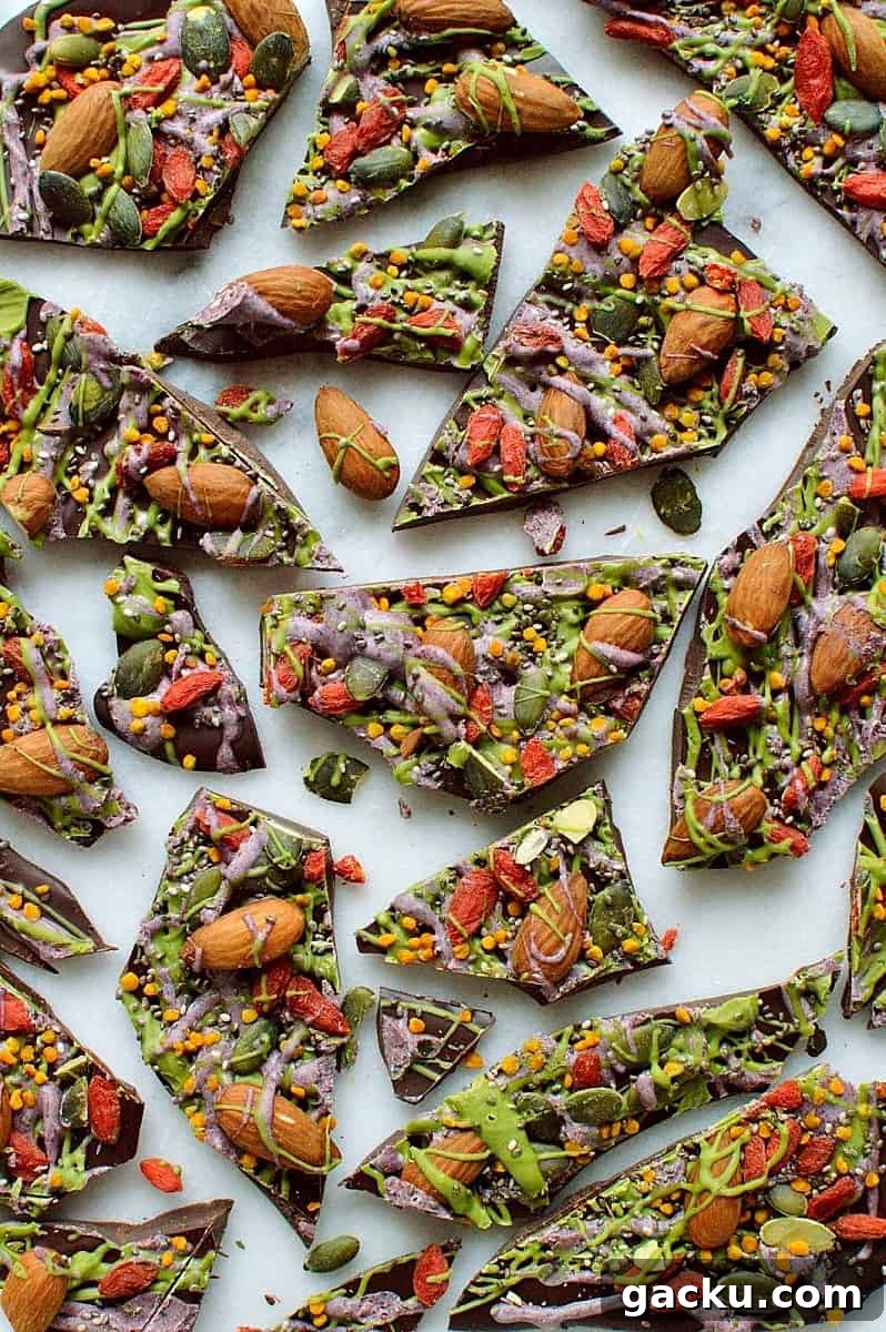 Superfood Chocolate Bark Recipe with Nuts & Seeds 7 Superfood chocolate bark - dark chocolate topped with almonds, goji berries, seeds, bee pollen and white chocolate flavoured with matcha and freeze dried blueberry powder