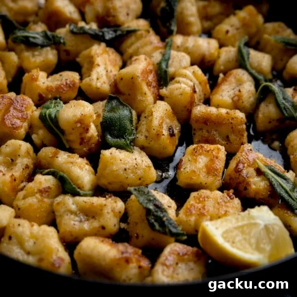 Creamy Baked Gnocchi with Chicken and Parmesan Crisp 7 Close up of gnocchi with brown butter and sage in a pan with lemon