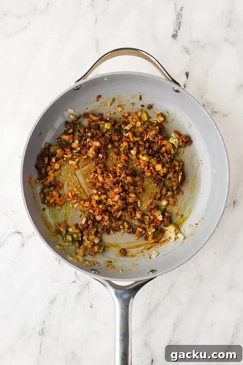 Restaurant-Style Chickpea Tikka Masala Recipe 6 An overhead image of adding the spices.