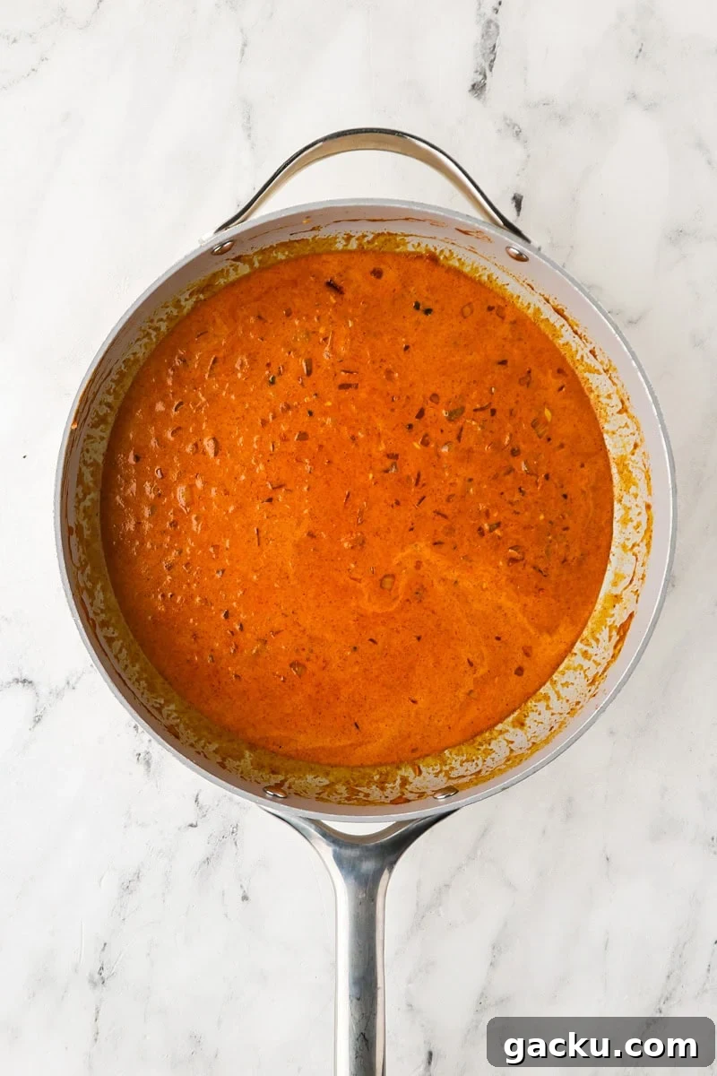 Restaurant-Style Chickpea Tikka Masala Recipe 8 An overhead image of adding cream to the mixture.