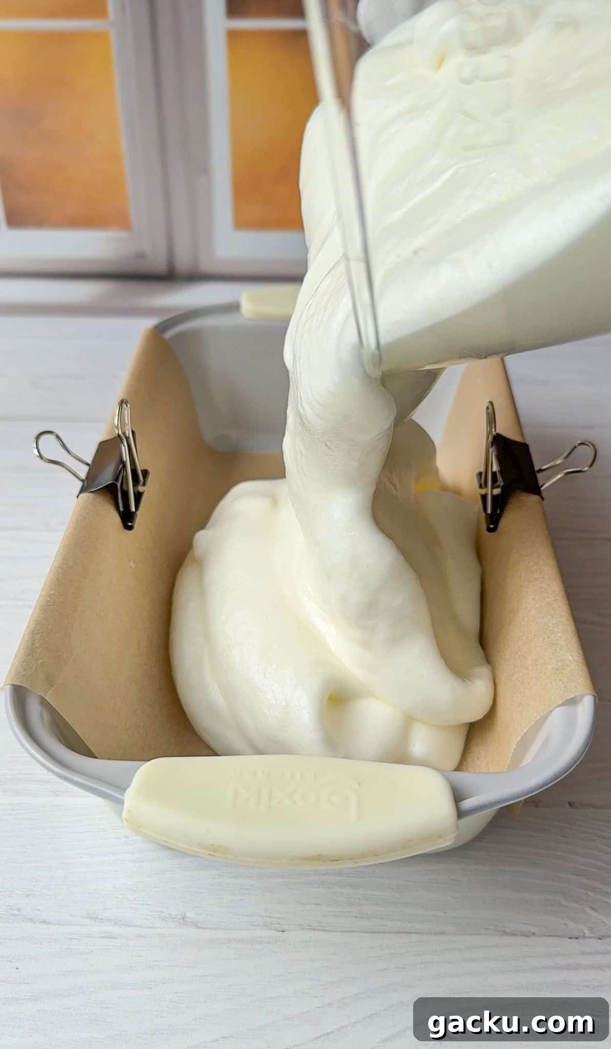 Fluffy Cloud Bread Recipe: Soft, Airy Sandwich Loaf in Minutes 7 The Cloud Bread batter is being poured into a parchment lines bread pan.