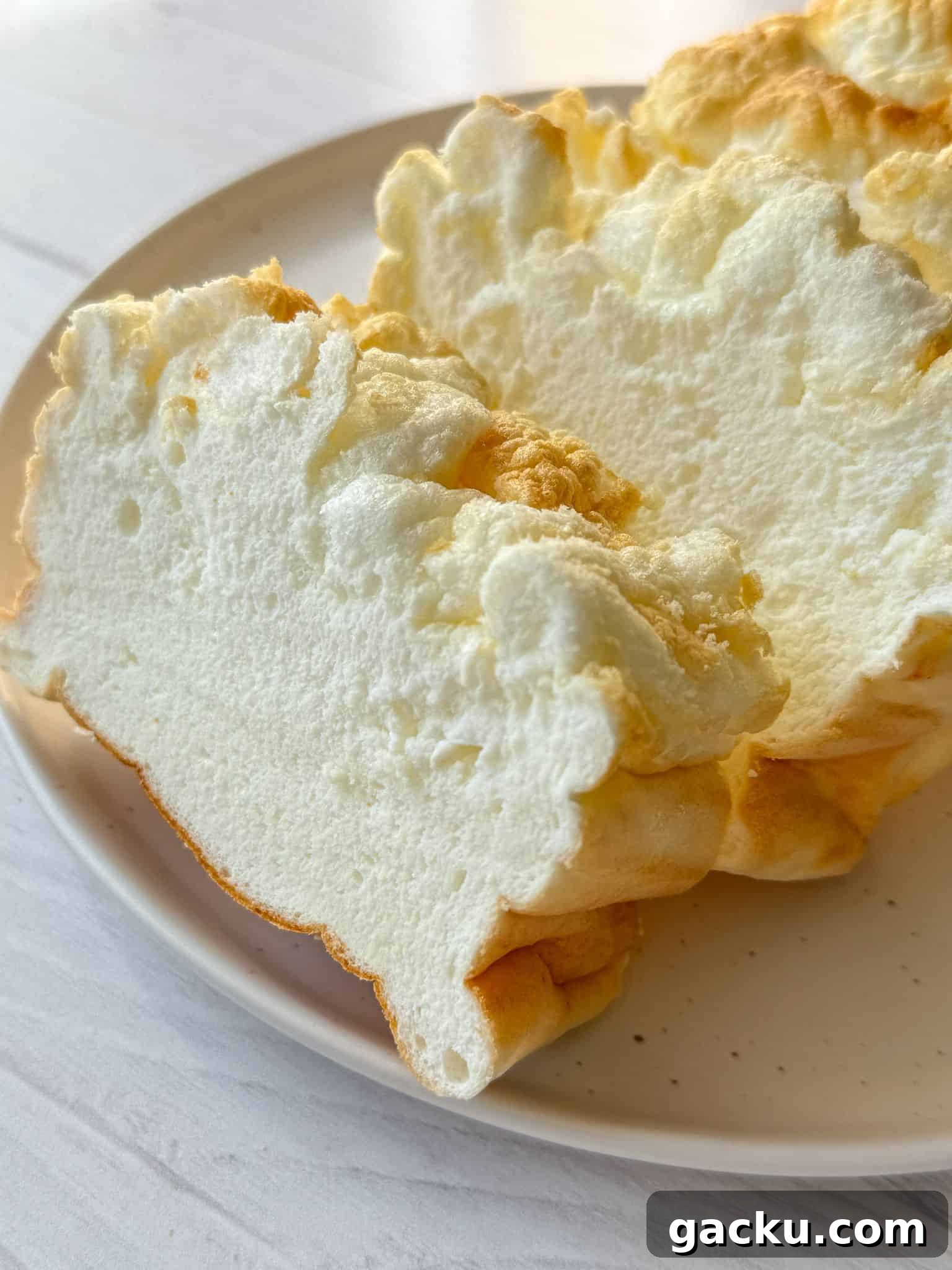 Fluffy Cloud Bread Recipe: Soft, Airy Sandwich Loaf in Minutes 8 A photo featuring the best cloud bread recipe. The bread is freshly baked and sliced on a plate.
