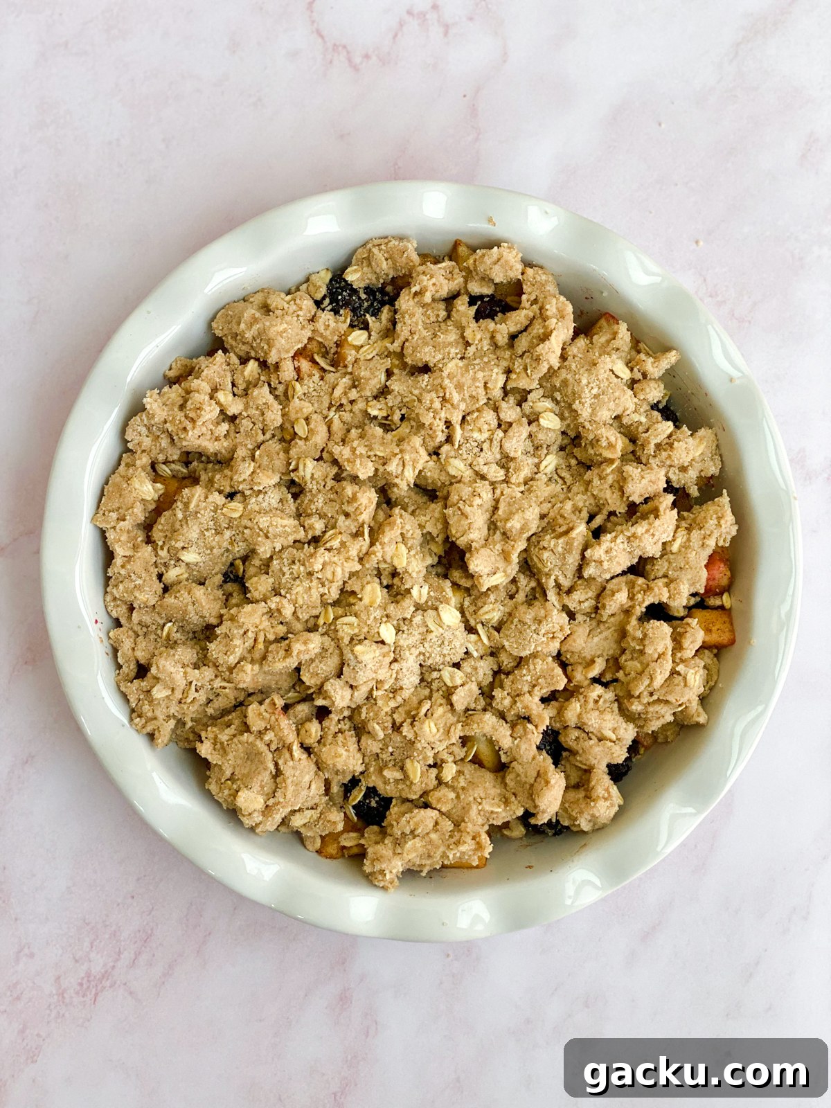 Blackberry Apple Crumble Recipe: Rustic Dessert with Oat Topping 9 topping placed on the crumble.