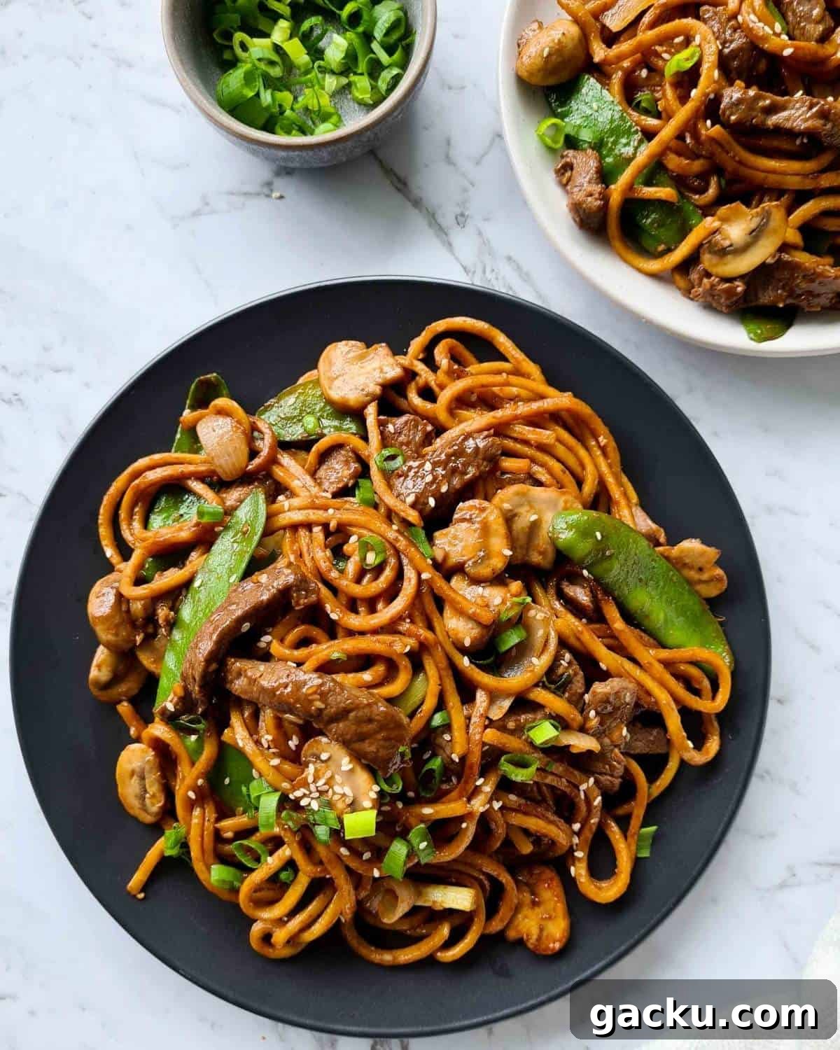 Szechuan Beef Stir-Fry with Noodles: Quick Weeknight Recipe 12 Freshly cooked beef noodle stir fry in a black plate