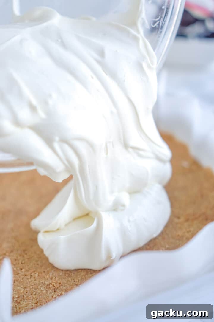 Creamy No-Bake Lemon Cheesecake Bars Recipe 6 pouring cheesecake into the crust