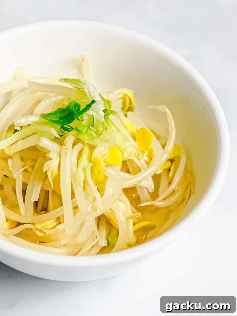 Korean soybean sprout side dish, kongnamul muchim, in a white bowl