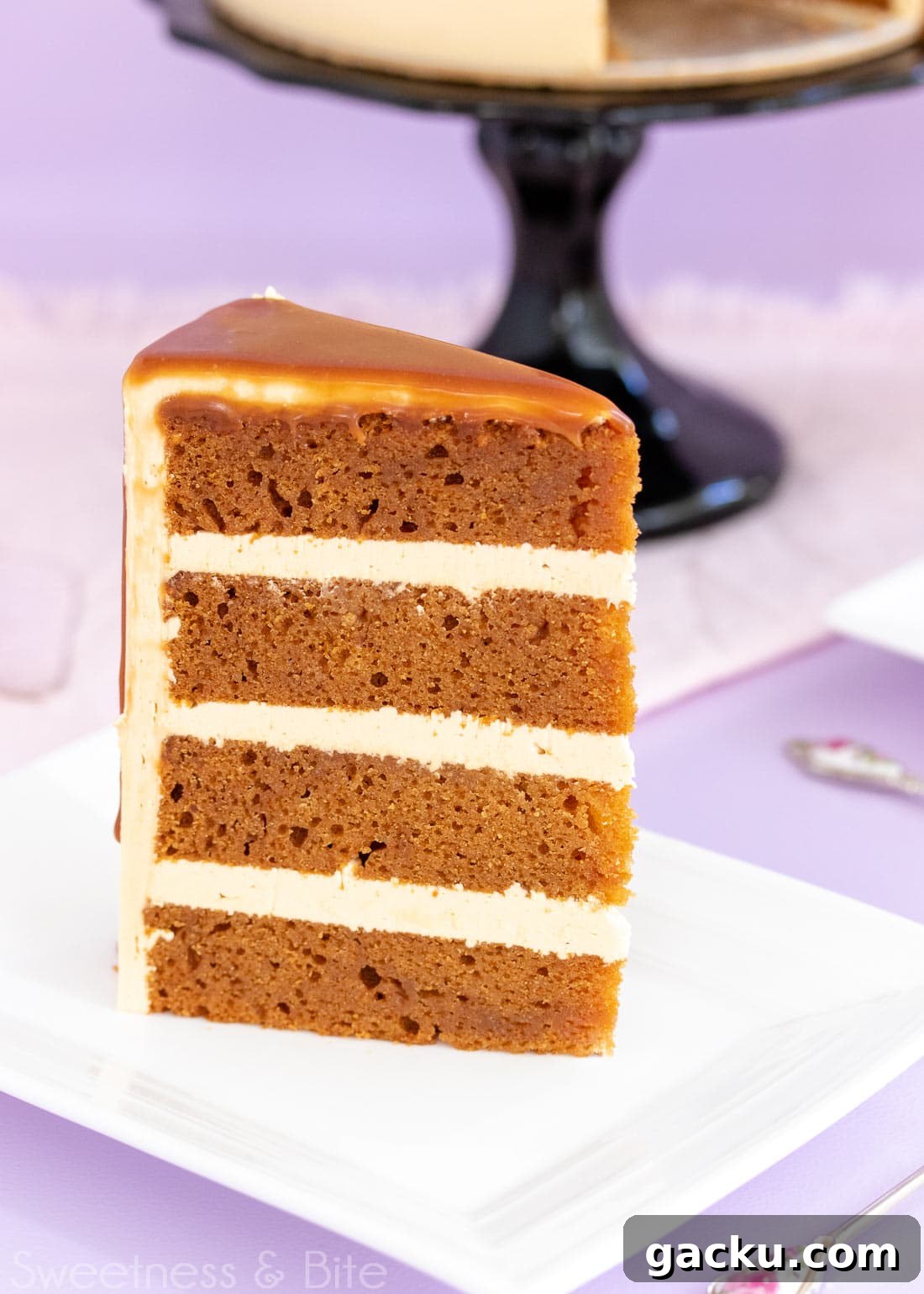 Close up of a slice of caramel mud cake with three layers of caramel buttercream.