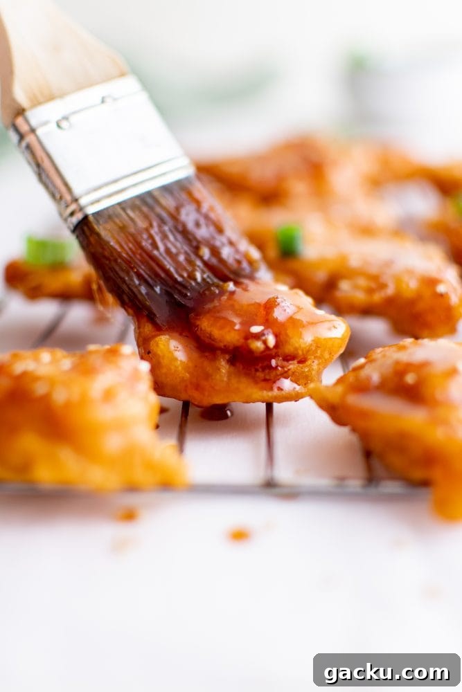 picture of sesame chicken on a bowl of rice
