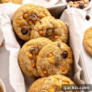 Chewy Butterscotch Chocolate Chip Cookies — No-Chill Dough Recipe 14 Close up butterscotch chocolate chip cookies on a white parchment lined loaf pan.