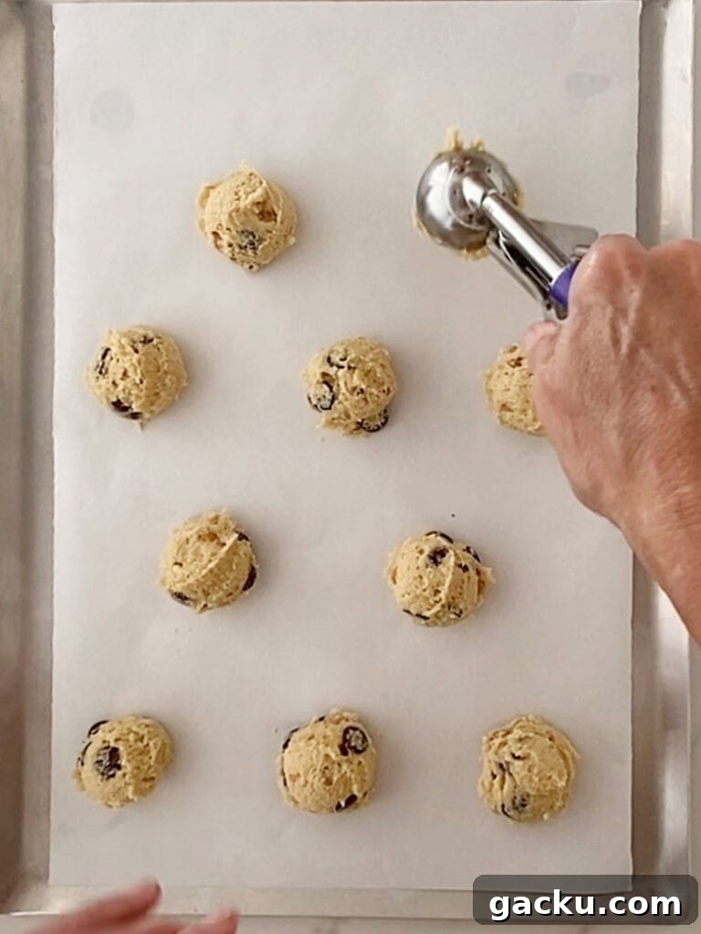 Chewy Butterscotch Chocolate Chip Cookies — No-Chill Dough Recipe 7 Scooping cookies on a parchment lined baking sheet. Top view.