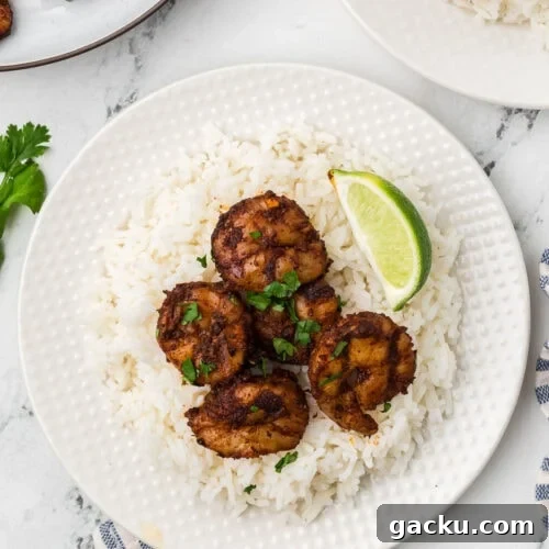 Juicy grilled chicken skewers served with fluffy white rice and fresh lime wedge. Perfect for flavorful, easy dinner recipes.