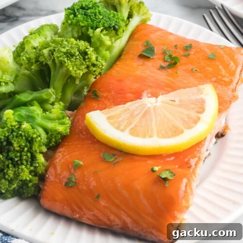 Salmon and broccoli on a white plate.