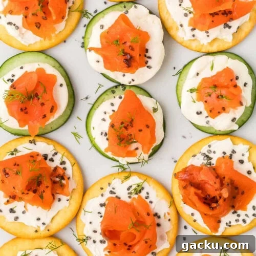 Cold smoked salmon slices topped on crackers with cream cheese.