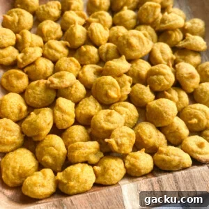 Kid-Friendly Halloween Snack Ideas Kids Will Love 13 Pumpkin puffs served on a wooden plate